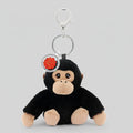 Plush monkey keychain with a red emblem on a white background