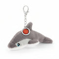 Plush shark keychain with a tag on a white background