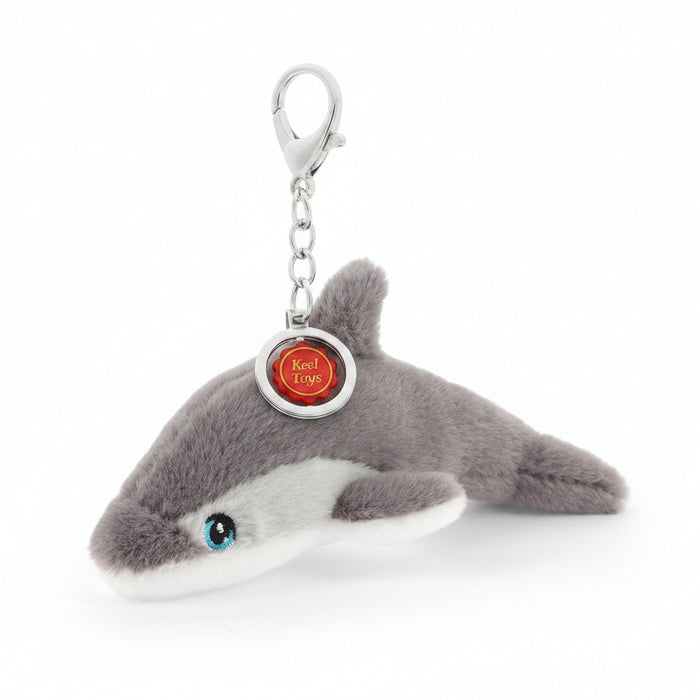 Plush shark keychain with a tag on a white background