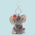 Plush elephant keychain with a silver ring and red tag on a white background