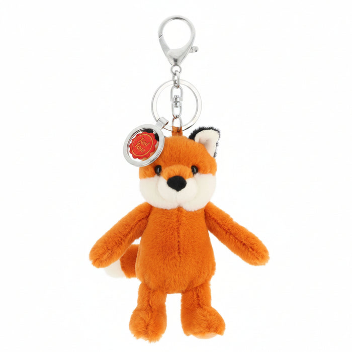 A small plush fox keychain in orange, cream, and black, attached to a silver metal key ring and clasp, with a round red and white tag on a plain white background.