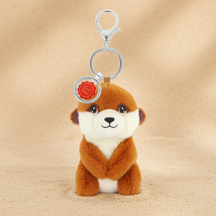 Plush meerkat keychain with a tag on a white background
