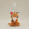 Plush tiger keychain with a silver ring and red emblem on a white background