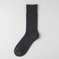 A single dark charcoal blue ribbed knit sock displayed flat against a light gray background.