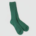 Green sock on a light gray background