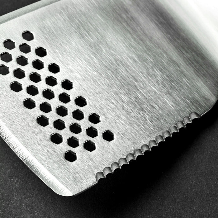A closeup of the end of a HexClad spatula. There are many small holes on the end of the spatula.