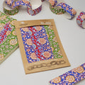 Packaged colorful fabric with floral patterns on a wooden board