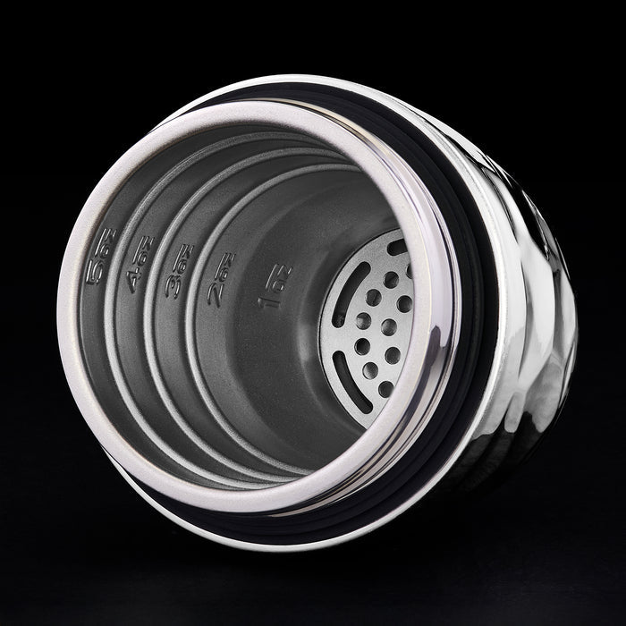 Close-up of a hexclad cocktail shaker top showing the inside with a black background