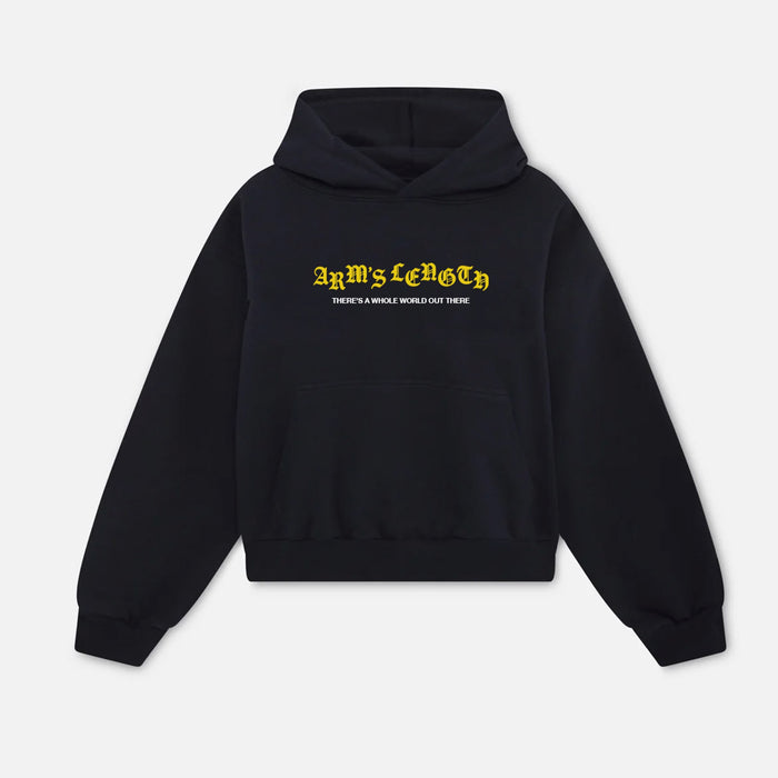 A black Arm's Length midweight pullover hoodie features a front pouch pocket and bold yellow ARMS LENGTH print with smaller white text: THERE'S A WHOLE WORLD OUT THERE.