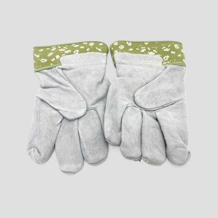 A pair of light gray leather gardening gloves with sage green floral patterned cuffs, displayed flat against a light gray background.