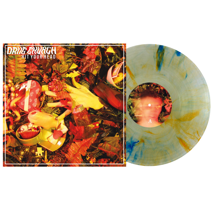 Vinyl Presale: Drug Church – Hit Your Head LP on Tide Pods Marble Vinyl, with yellow and blue marbling, plus an album cover featuring rubber gloves, a toy doll, and autumn leaves illuminated by red lighting.