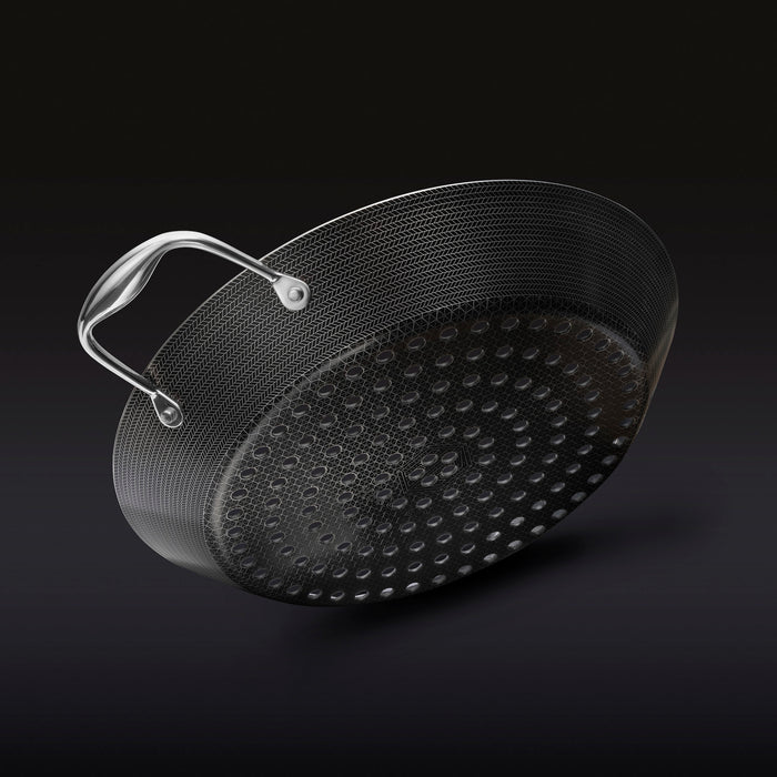 The underside of the HexClad 12&quot Hybrid BBQ Grill Pan on a black background