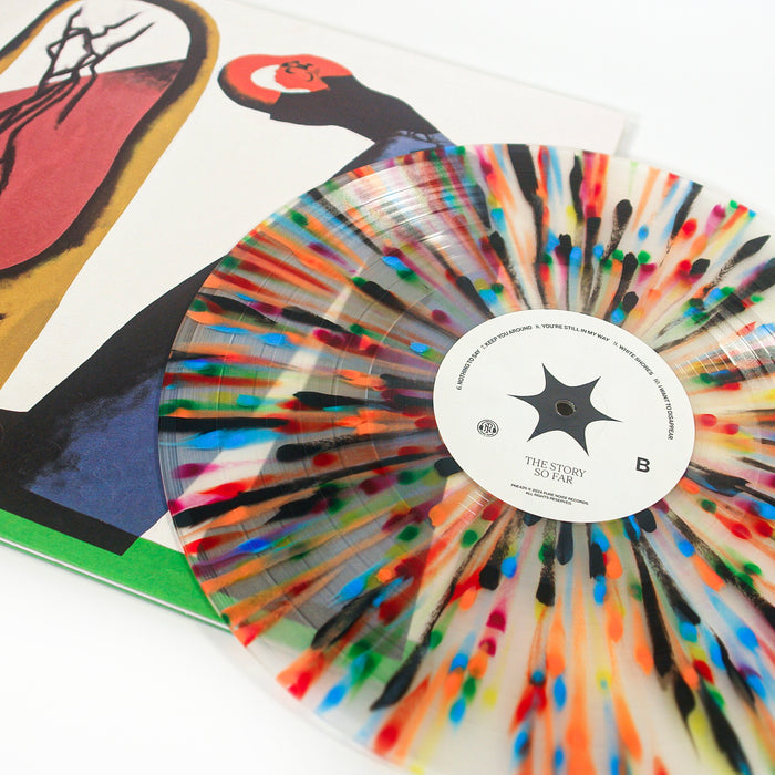 A limited edition milky clear vinyl record with rainbow splatter from The Story So Far sits on top of an abstract album cover featuring bold shapes and a red circle.