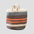 A woven jute basket with a striped pattern in blue-gray, brown, cream, and orange, featuring two natural jute handles, shown against a plain white background.