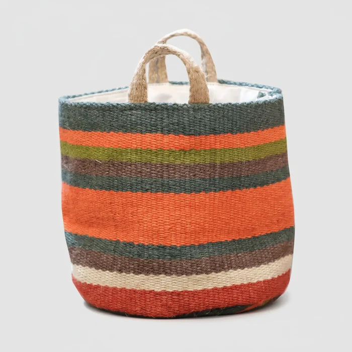A woven storage basket with horizontal stripes in orange, dark green, brown, beige, and white, featuring two natural jute handles on a white background.