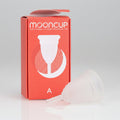 A Mooncup menstrual cup in white color, displayed next to its orange packaging with the brand name and size 'A' indicated.