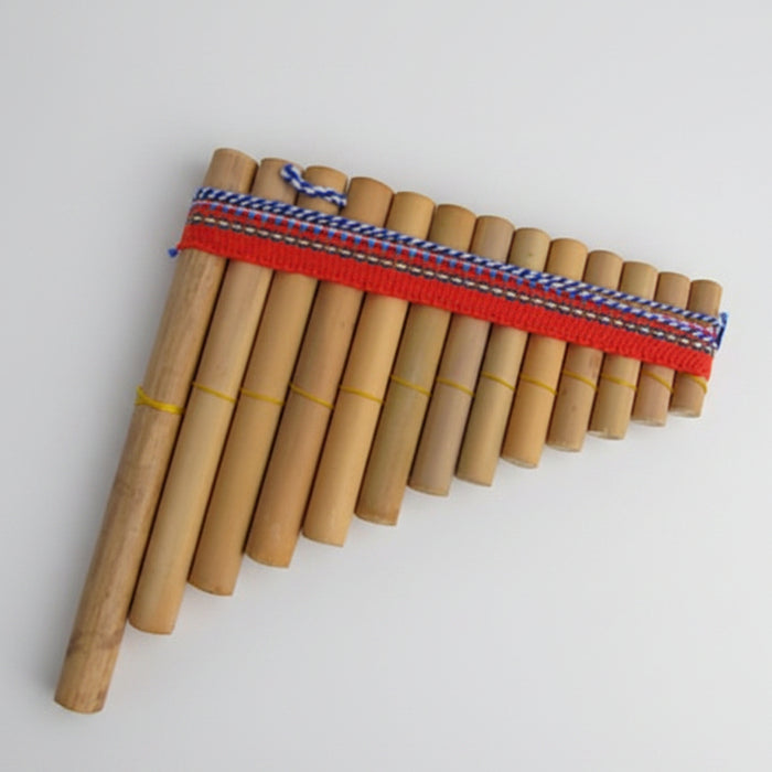 A traditional wooden pan flute instrument with multiple natural bamboo tubes arranged in a triangular shape, bound with a red cord and a blue-and-white patterned strap, shown on a plain white background.