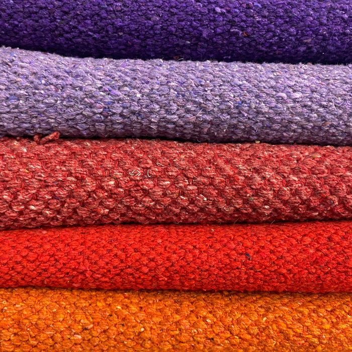 pile of brightly coloured cotton rugs