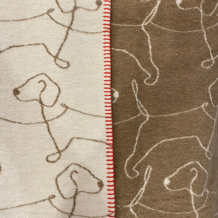 blanket , cream and brown with a repeated  line design of a dog