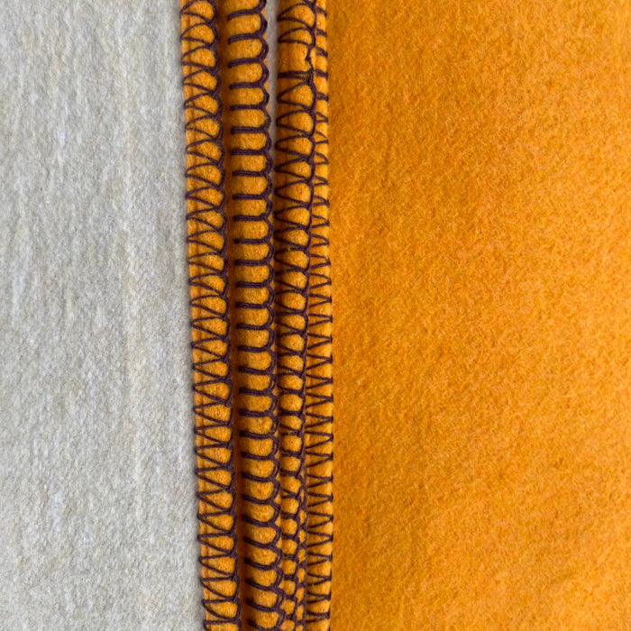 Custard recycled cotton blanket orange and beige on reverse