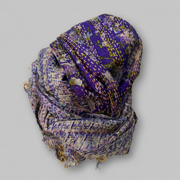 A purple silk sari scarf with floral patterns and kantha stitching, displayed on a neutral background.