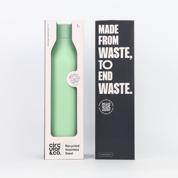 Green reusable water bottle in packaging with 'Made from Waste, To End Waste' text on a white background