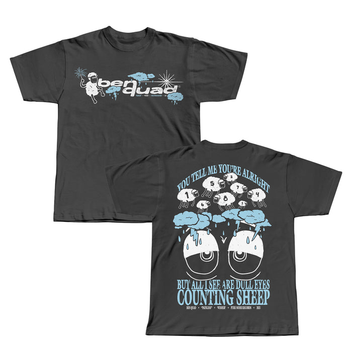 Front and back of a dark grey Ben Quad T-shirt. The front shows Bear Quad with a cartoon bear, stars, and blue clouds; the back features Sheep Pepper among sheep with numbers and the phrase: You tell me you’re alright but all I see are dull eyes counting sheep.