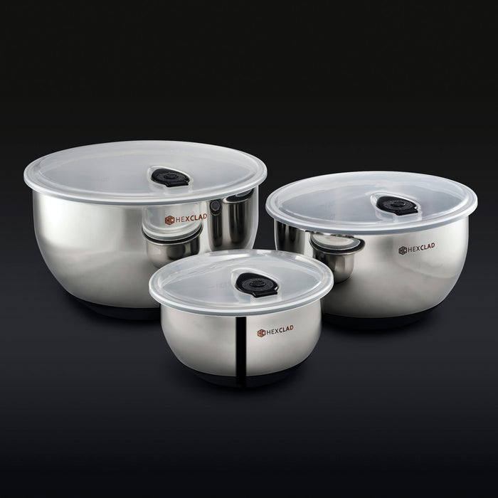3 HexClad stainless steel mixing bowls with vacuum seal lids on a black background.