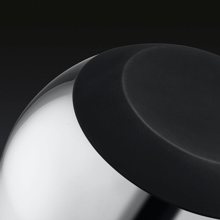 A closeup of the underside of a HexClad stainless steel mixing bowl.