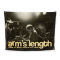 A vibrant 3 x 5 flag featuring a musician on stage and bold yellow and white Arms Length plus THERES A WHOLE WORLD OUT THERE text—now available as an exclusive Arms Length presale item.