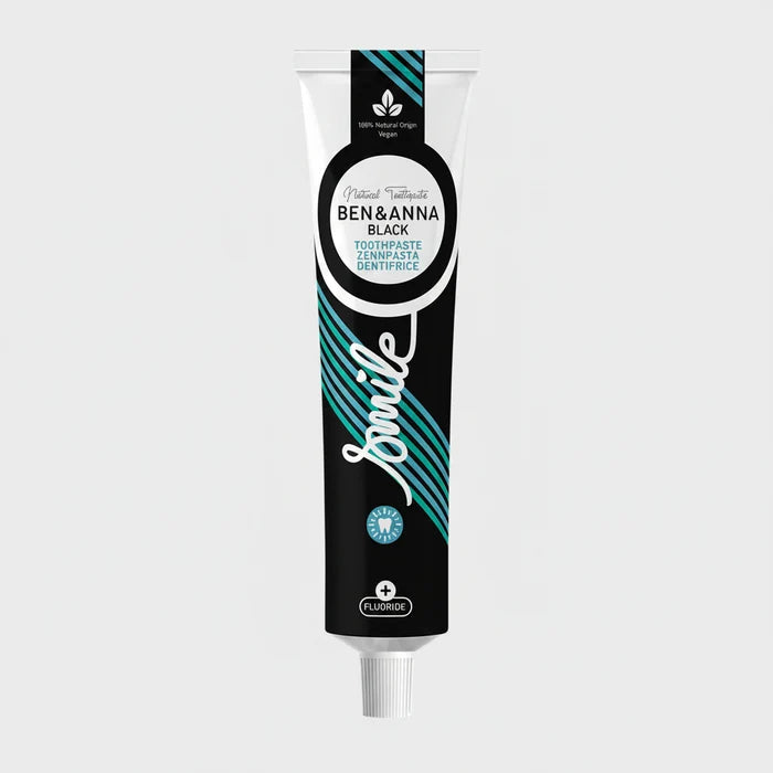 A tube of  Ben & Anna Smile toothpaste with a black, blue, and white color scheme, indicating it is vegan and contains fluoride.