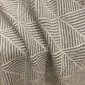 Close-up of a woven textile with a geometric basketweave pattern in taupe and gray.